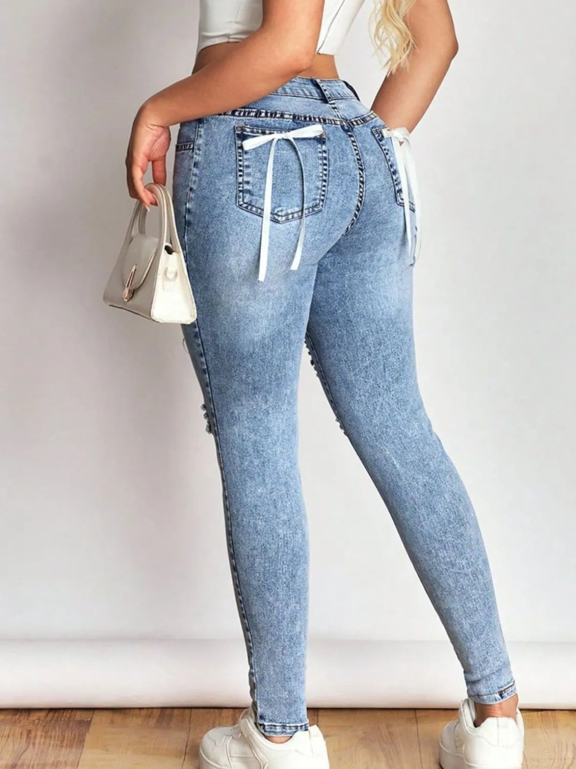 Distressed Skinny Jeans with Bow Back - Thalia Chic