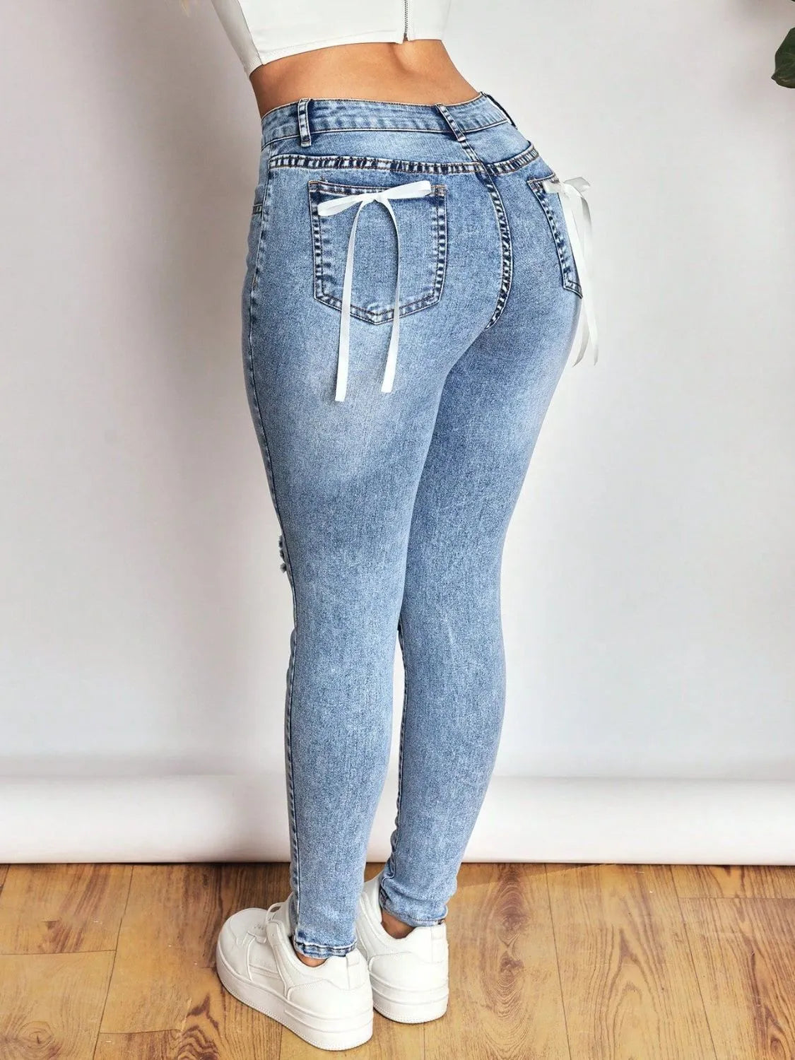 Distressed Skinny Jeans with Bow Back - Thalia Chic